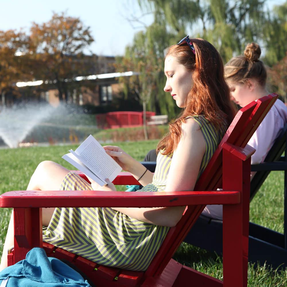 Student reading on campus